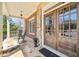 Charming front porch with stone accents, rocking chairs, and an inviting double-door entrance at 3149 Hidden Falls Ne Dr, Buford, GA 30519