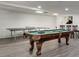 Finished basement contains a pool table, ping pong table, recessed lighting, and gray floors at 2970 Oxford Rd, Atlanta, GA 30349