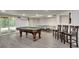 Finished basement offers a pool table, ping pong table, recessed lighting, and access to the backyard at 2970 Oxford Rd, Atlanta, GA 30349