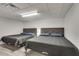 Finished basement with gray floors features two queen beds with gray quilts and recessed lighting at 2970 Oxford Rd, Atlanta, GA 30349