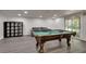 Finished basement provides a pool table, gray floors, access to the backyard, and a gray couch at 2970 Oxford Rd, Atlanta, GA 30349