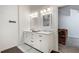 Bright bathroom with double sink vanity and doorway leading to bonus room at 2970 Oxford Rd, Atlanta, GA 30349