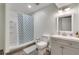 Updated bathroom featuring a shower with patterned curtain, modern vanity, and neutral wall color at 2970 Oxford Rd, Atlanta, GA 30349