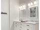 Bright bathroom with a double sink vanity, marble countertop, and modern fixtures at 2970 Oxford Rd, Atlanta, GA 30349