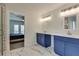 This modern bathroom features a double vanity, large mirror, and a walk-in shower nearby the main bedroom at 2970 Oxford Rd, Atlanta, GA 30349
