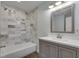 Cozy bathroom featuring a white vanity, large mirror, and a tub with a tiled shower at 2970 Oxford Rd, Atlanta, GA 30349