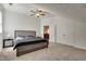 Spacious bedroom featuring carpet, ceiling fan, closet, and doorway leading to bonus room at 2970 Oxford Rd, Atlanta, GA 30349