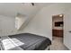 Bedroom with neutral paint features a queen bed with a gray quilt and access to the living room at 2970 Oxford Rd, Atlanta, GA 30349