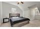 A bedroom features neutral paint, a ceiling fan, and a queen bed with a gray quilt at 2970 Oxford Rd, Atlanta, GA 30349