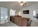 Spacious bonus room with a large sectional sofa, ceiling fan, and wall-mounted television at 2970 Oxford Rd, Atlanta, GA 30349