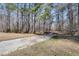 Gravel driveway with mature trees and a path leading to the house at 2970 Oxford Rd, Atlanta, GA 30349