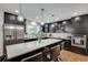 Modern kitchen featuring sleek black cabinets, stainless steel appliances and marble countertops at 2970 Oxford Rd, Atlanta, GA 30349