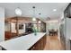 Open-concept living space with a kitchen island, dining area, and living room with fireplace at 2970 Oxford Rd, Atlanta, GA 30349