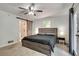 This bedroom features a ceiling fan, neutral colors, and an ensuite bathroom with a sliding barn door at 2970 Oxford Rd, Atlanta, GA 30349