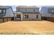 The spacious fenced-in back yard and home's exterior, offering an ideal space for relaxation and entertainment at 2121 Hempstead Ct, Snellville, GA 30078