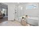 Serene bathroom with a separate frameless shower and tub, offering a relaxing space with natural light at 2121 Hempstead Ct, Snellville, GA 30078