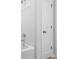 Bright bathroom featuring a tub with showerhead and two white doors, tiled floors at 2121 Hempstead Ct, Snellville, GA 30078