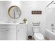 Bathroom featuring a toilet, tub/shower, and vanity, decorated with a modern patterned wallpaper at 2121 Hempstead Ct, Snellville, GA 30078