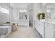 Elegant bathroom features dual vanity, soaking tub, frameless shower and tile flooring for a spa-like experience at 2121 Hempstead Ct, Snellville, GA 30078