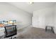 Bright bedroom featuring plush carpet, neutral walls, and a workspace with dual monitors at 2121 Hempstead Ct, Snellville, GA 30078