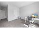 Spacious bedroom with gray carpet, natural light, and functional workspace with monitor at 2121 Hempstead Ct, Snellville, GA 30078