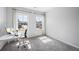 Comfortable bedroom featuring soft carpet, light grey walls, and large windows overlooking the neighborhood at 2121 Hempstead Ct, Snellville, GA 30078