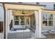 Inviting covered patio with comfortable seating, ceiling fan, and stylish curtains, perfect for outdoor relaxation and entertaining at 2121 Hempstead Ct, Snellville, GA 30078
