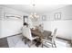 Elegant dining room featuring wainscoting, a modern chandelier, and a stylish area rug at 2121 Hempstead Ct, Snellville, GA 30078