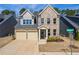 Charming two-story brick home with a two-car garage and manicured front yard in a desirable neighborhood at 2121 Hempstead Ct, Snellville, GA 30078