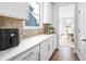 Clean kitchen with white cabinets, quartz countertops and stainless steel appliances at 2121 Hempstead Ct, Snellville, GA 30078