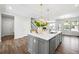 Bright open-concept kitchen with a large island, modern lighting, and stainless steel appliances at 2121 Hempstead Ct, Snellville, GA 30078