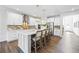 Well-lit kitchen with a large island, seating, stainless appliances, and white cabinets at 2121 Hempstead Ct, Snellville, GA 30078
