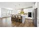 Open-concept kitchen with a large island, stainless steel appliances, and hardwood floors at 2121 Hempstead Ct, Snellville, GA 30078