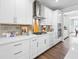 Modern kitchen featuring white cabinetry, stainless steel appliances, and stylish backsplash at 2121 Hempstead Ct, Snellville, GA 30078