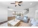 Bright, open-concept living space with hardwood floors, a stylish rug, and a view into the kitchen at 2121 Hempstead Ct, Snellville, GA 30078