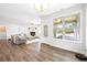 Bright living room featuring hardwood floors, large windows, and a cozy fireplace at 2121 Hempstead Ct, Snellville, GA 30078