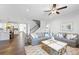 Bright living room with hardwood floors, neutral paint, and a staircase visible in an open-concept design at 2121 Hempstead Ct, Snellville, GA 30078