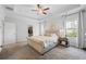 Bright main bedroom with a tray ceiling, carpet, a walk-in closet, and neutral colored walls at 2121 Hempstead Ct, Snellville, GA 30078