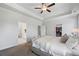 Bright and airy main bedroom with tray ceiling, ceiling fan, carpet, and ensuite bathroom and walk-in closet at 2121 Hempstead Ct, Snellville, GA 30078
