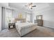 Spacious primary bedroom with a tray ceiling, carpet, two windows, and neutral decor at 2121 Hempstead Ct, Snellville, GA 30078