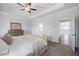 Spacious main bedroom featuring neutral decor, carpet, and an ensuite bathroom for added comfort and privacy at 2121 Hempstead Ct, Snellville, GA 30078