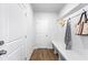 Mud room with a bench, hooks for coats, and a door leading to the exterior or garage at 2121 Hempstead Ct, Snellville, GA 30078