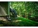 Wooden stairs lead to the elevated deck of the house, surrounded by lush greenery at 3013 Rockview Dr, Loganville, GA 30052
