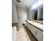 Well-lit bathroom featuring a double vanity with tiled countertops, providing ample space and storage at 3013 Rockview Dr, Loganville, GA 30052