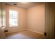 Cozy bedroom with neutral carpet, window offering natural light, and fresh paint, creating a serene atmosphere at 3013 Rockview Dr, Loganville, GA 30052