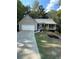 Charming single-story home features a stone accent front porch and a well-maintained lawn at 3013 Rockview Dr, Loganville, GA 30052