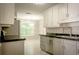 Modern kitchen with stainless appliances, sleek countertops, and white cabinets at 3013 Rockview Dr, Loganville, GA 30052