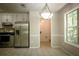 Bright kitchen with stainless steel appliances, white cabinets, and access to the laundry room at 3013 Rockview Dr, Loganville, GA 30052