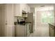 Kitchen with stainless appliances, black countertop, white cabinets, and tile flooring at 3013 Rockview Dr, Loganville, GA 30052