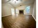Spacious living room with fireplace, wood floors, and vaulted ceiling, perfect for entertaining guests at 3013 Rockview Dr, Loganville, GA 30052